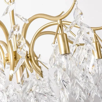 A decorbites crystal chandelier with delicate gold-toned frame and cascading clear crystal leaves for modern luxury lighting