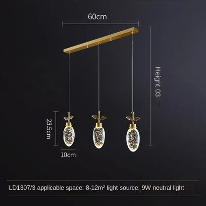 Gold-toned decorbites crystal chandelier with three pineapple-shaped glass globes and LED lights for modern luxury lighting