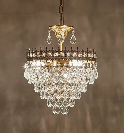 A decorbites crystal chandelier with tiered clear faceted crystals and a gold-toned metal frame for luxury lighting
