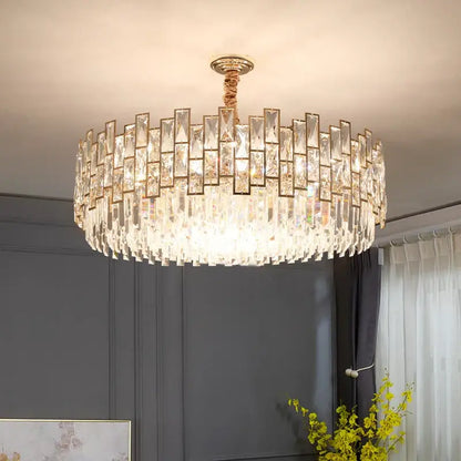 Decorbites crystal chandelier with clear faceted prisms in concentric rings and gold metal frame for modern luxury lighting