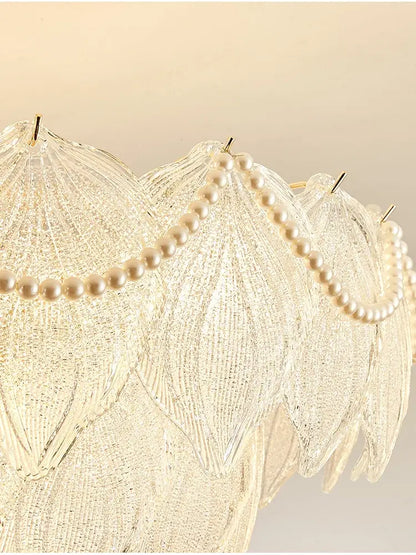 A decorbites crystal chandelier with translucent glass leaves and cream pearls for modern luxury lighting