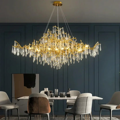 Golden decorbites crystal chandelier with intricate branch-like design and dangling crystal droplets for modern luxury lighting