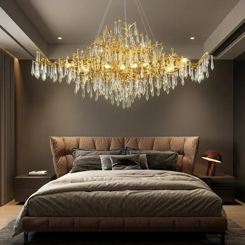 Golden decorbites crystal chandelier with crystal droplets hanging above the bed for modern luxury lighting