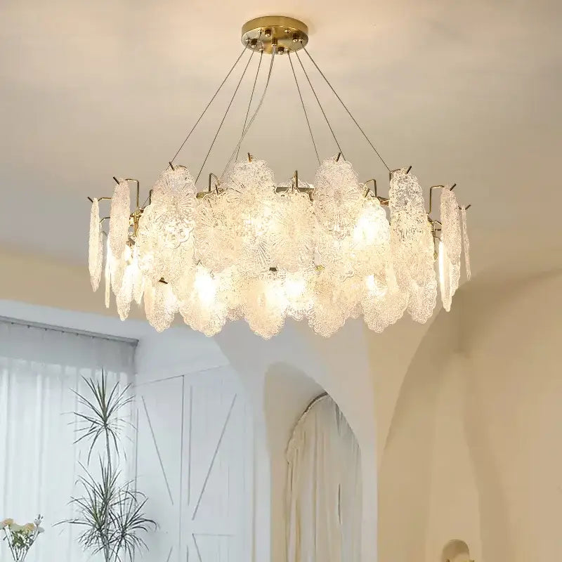 Elegant gold-toned decorbites crystal chandelier with translucent frosted glass petals for modern luxury living room