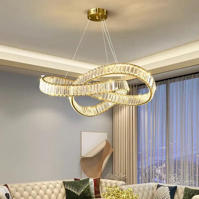 Gold-toned decorbites crystal chandelier pendant lamp with infinity loop design and faceted crystal accents for modern rooms