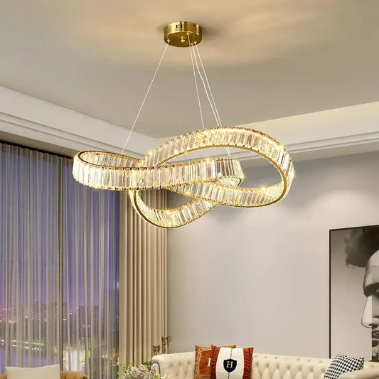 Gold-toned decorbites crystal chandelier pendant lamp with infinity loop design and faceted crystal accents for modern home lighting