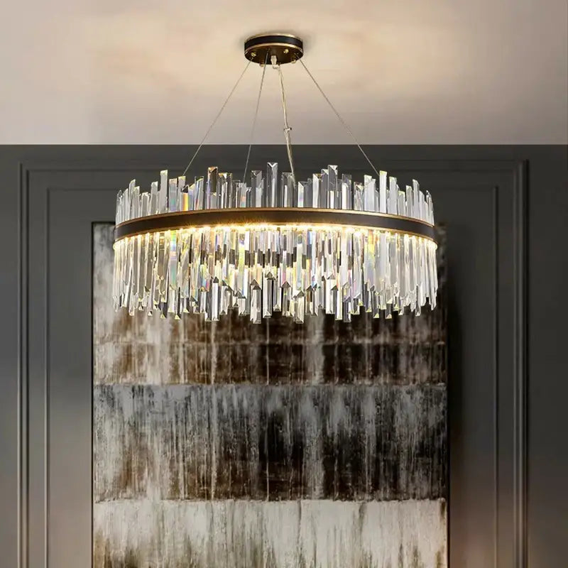 Decorbites crystal chandelier pendant light with clear crystal prisms and brass frame illuminated by warm led lights
