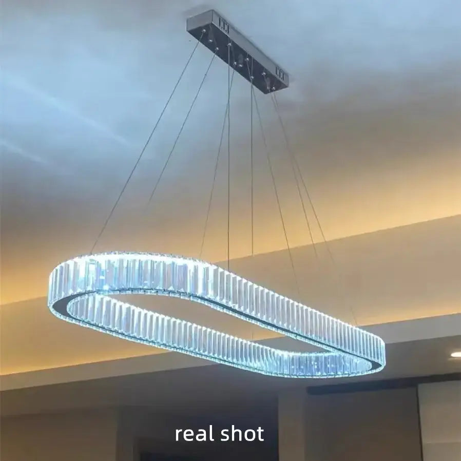 Modern oval-shaped decorbites crystal chandelier pendant light with chrome finish and clear crystal rods emitting bright white light