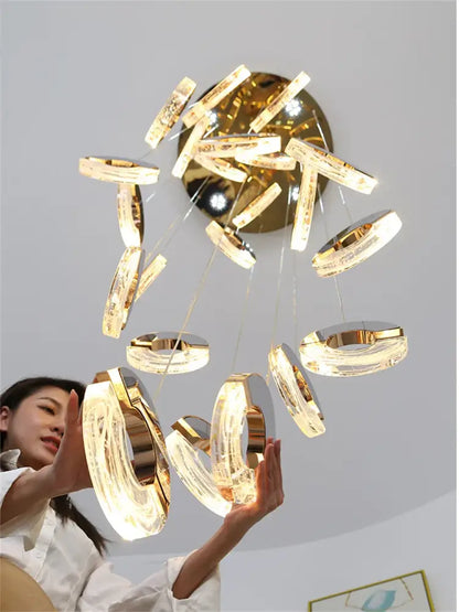 Golden decorbites crystal chandelier pendant light with circular translucent acrylic rings and brass fixture for various spaces