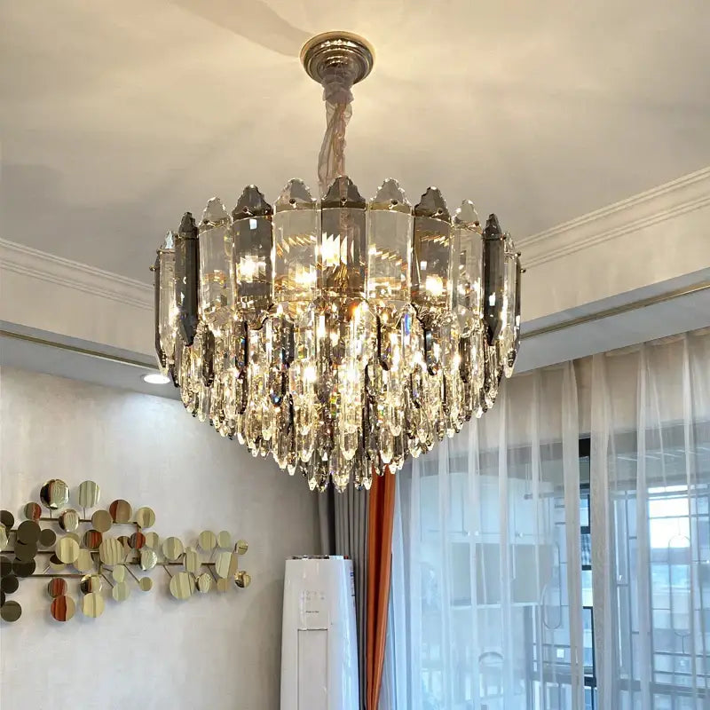 Decorbites crystal chandelier with gold-toned frame and cascading clear and dark gray crystals for luxury living rooms