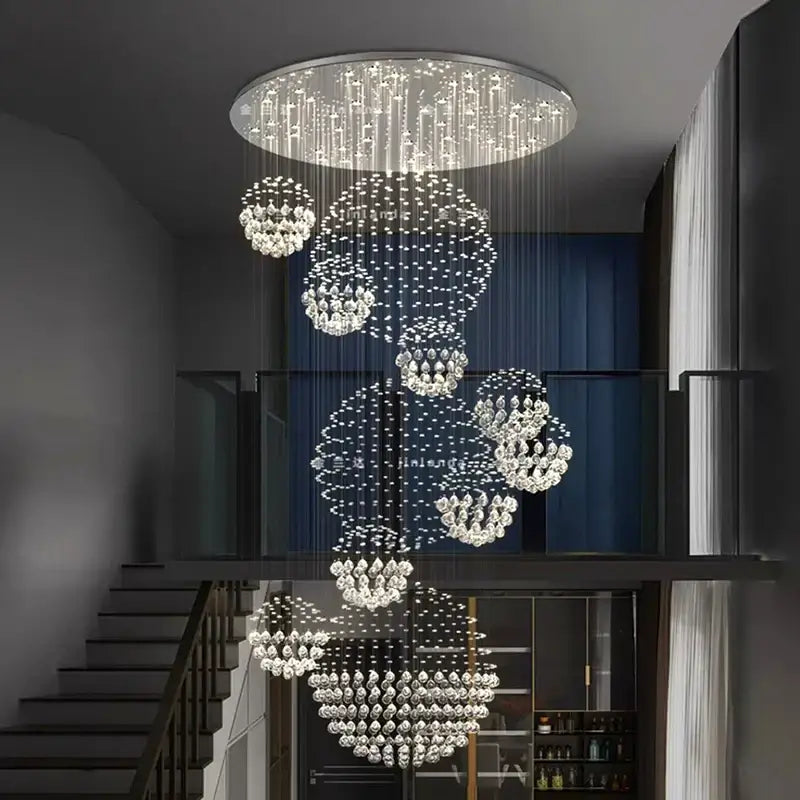 A modern decorbites crystal chandelier with cascading crystal spheres in a chandelier stair pendant for living room lighting