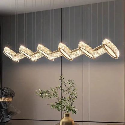 Gold-toned crystal chandelier stair pendant with zigzag design by DecorBites for modern living room lighting