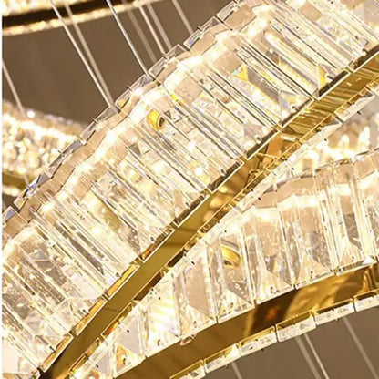 A decorbites crystal chandelier with cascading clear faceted prisms and polished gold metal for living room lighting
