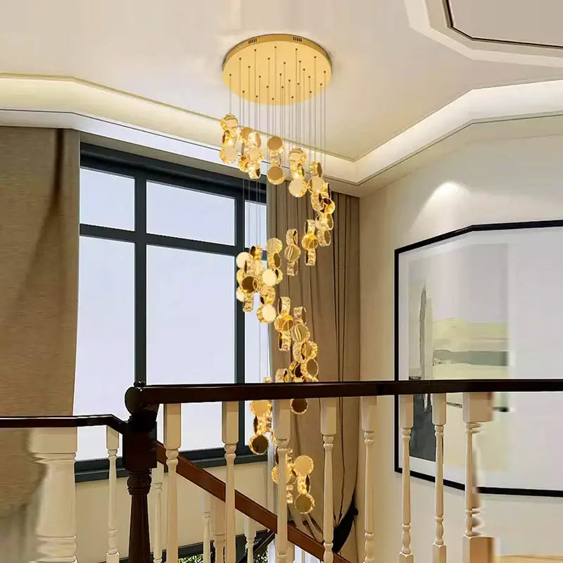 Golden circular decorbites crystal chandelier with cascading crystal discs and polished brass ceiling fixture for stair pendant lighting