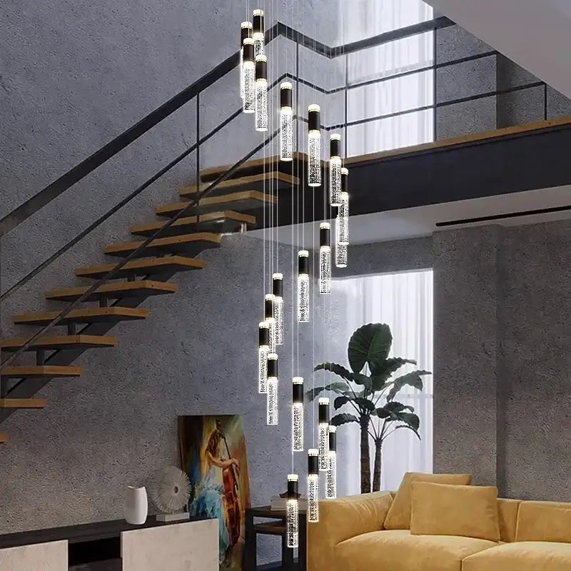 Modern cylindrical DecorBites crystal chandelier with black and clear glass elements lighting a living room stair pendant