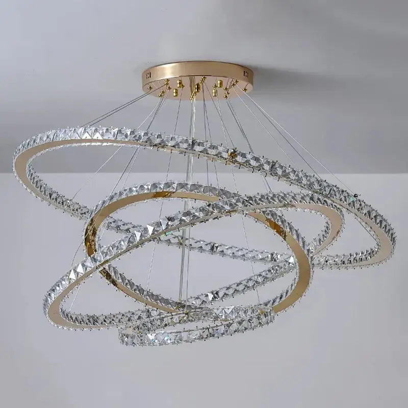 A modern decorbites crystal chandelier stair pendant light with gold-toned rings and clear crystals for interior lighting