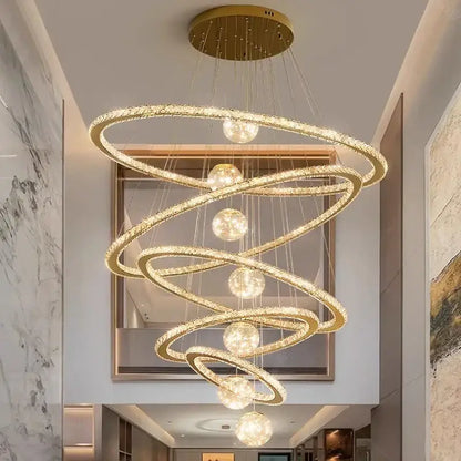 Decorbites crystal chandelier featuring golden spiral design with crystal-encrusted rings and spherical light fixtures