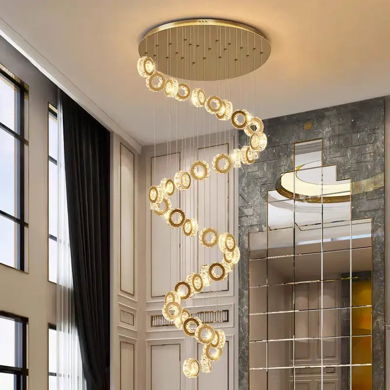 Golden spiral DecorBites crystal chandelier pendant light with crystal rings and circular ceiling mount for stair lighting