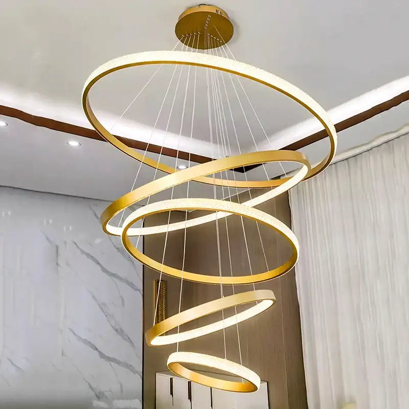A modern decorbites crystal chandelier pendant lamp with gold concentric rings and led lighting for stair or living room