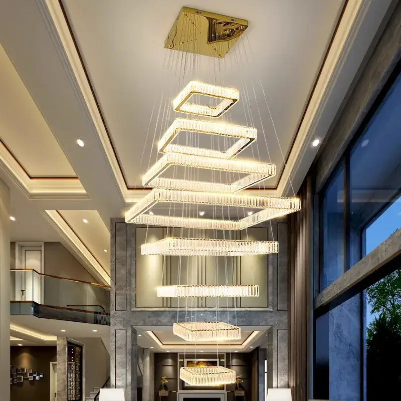 A modern decorbites crystal chandelier stair pendant light with cascading rectangular crystal tiers and gold finish
