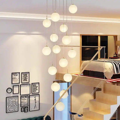 Modern spherical pendant light with frosted glass orbs and metallic chains in decorbites crystal chandelier stair design