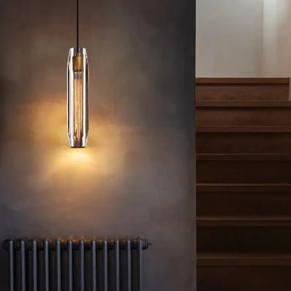 A modern decorbites crystal copper chandelier with clear glass cylinder and exposed filament bulb for living room lighting