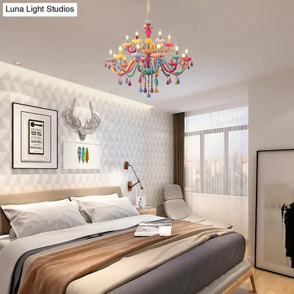 A vibrant multi-colored DecorBites™ crystal decorated kids chandelier with teardrop ornaments for kindergarten