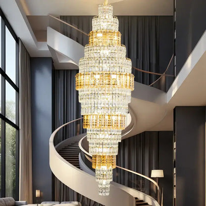 Decorbites crystal duplex multi-tiered chandelier with gold accents hanging above spiral staircase for luxe living room lighting