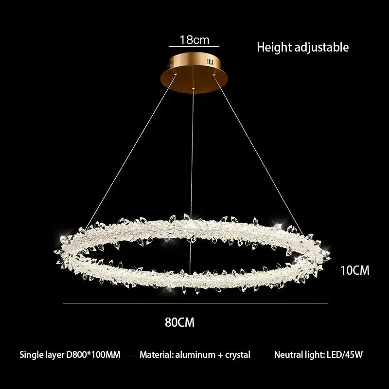 A decorbites crystal flower led chandelier with gold mount and clear crystals emitting neutral LED light for dining rooms