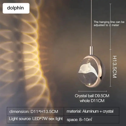 A sleek decorbites crystal jellyfish gold bedroom pendant light with a dolphin-shaped crystal on an aluminum chain