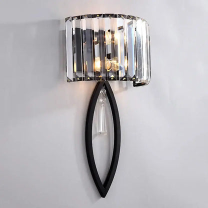A sleek black metal decorbites crystal led wall lamp with curved frame and vertical crystal prisms for bedroom lighting