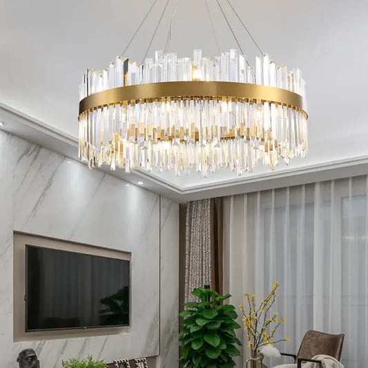 Gold-toned circular decorbites crystal led chandelier with cascading clear crystal prisms for dining room lighting