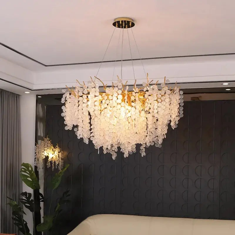 A modern decorbites crystal led chandelier with gold-toned frame and cascading clear crystal discs for dining room