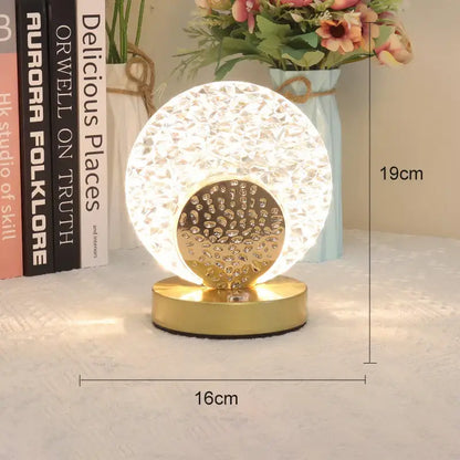 Gold-toned decorbites crystal led table lamp with faceted crystal globe and ornate base for bedroom lighting