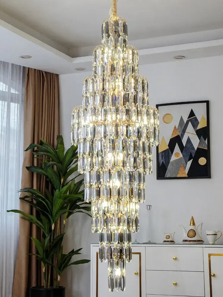 Crystal spiral tiered loft pendant light with cascading clear glass prisms and warm glowing lights for staircase and living room