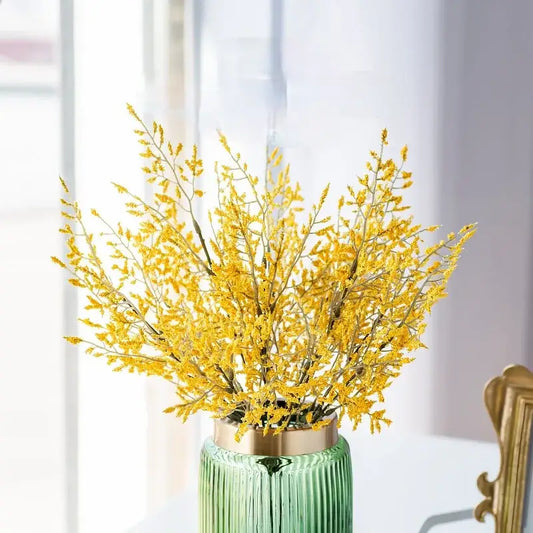 Mint green ceramic vase with gold rim holding a lemon grass branch arrangement for living room decor