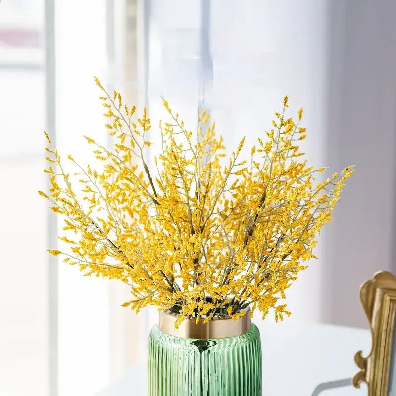 Mint green ceramic vase with gold rim holding a lemon grass branch arrangement for living room decor