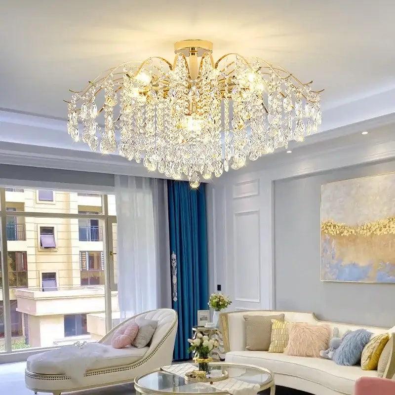 A luxurious gold-toned crystal luxe led chandelier with cascading clear glass droplets for living room decor
