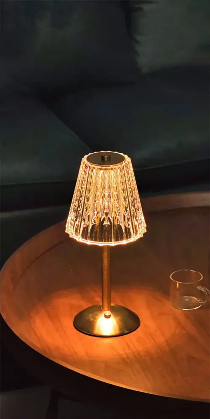 A warm-glowing decorbites™ crystal retro table lamp with brass base and textured glass shade for bedroom ambiance