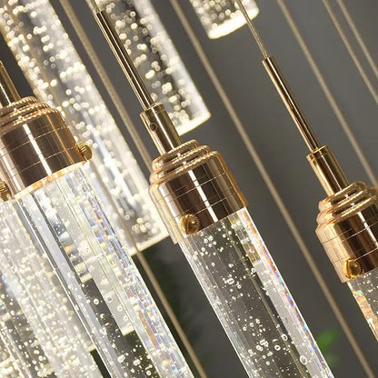 Clear glass decorbites crystal staircase chandelier with gold-toned metal fixtures and internal led lights for modern interiors