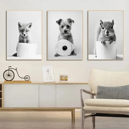 Three framed black and white cute animals canvas wall art featuring a fox puppy and squirrel on toilet paper rolls for bathroom decor