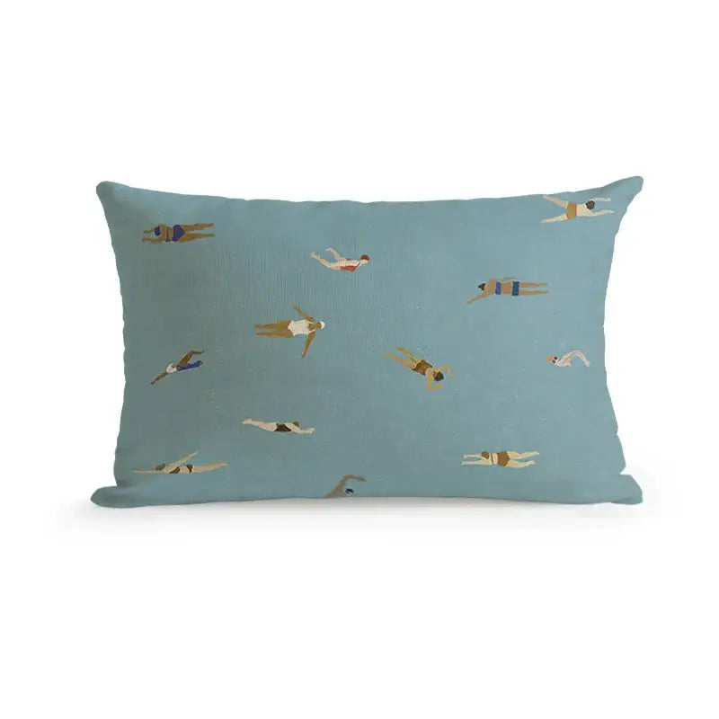 A rectangular light blue pillow with stylized swimming illustrations paired with decorbites cute dog printed cover