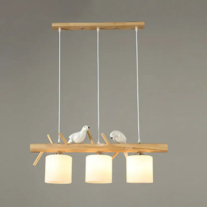 DecorBites™ cylindrical milk glass pendant light with wooden frame and white resin bird deco for country style restaurants