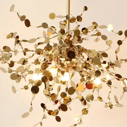 A shimmering gold decorbites dandelion chandelier with branch-like arms and reflective discs for dining room lighting