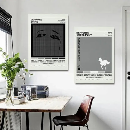 Two minimalist deftones canvas paintings featuring black and white ohms pixelated eye and white pony gray horse designs