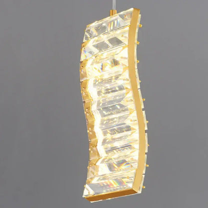 Gold-toned decorbites deluxe crystal pendant light with curved design and faceted crystal panels for dining room illumination