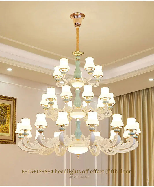 A decorbites deluxe duplex living room chandelier with ornate white glass arms blue columns and gold-toned accents
