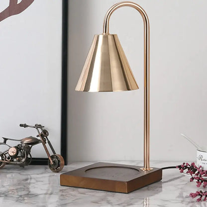 Brass bell-shaped dimmable candle warmer lamp with curved stem and square wooden base by DecorBites™