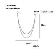 Minimalist u-shaped wall lamp with two slender metallic arms and 7w led bulb featuring flexible leather belt design
