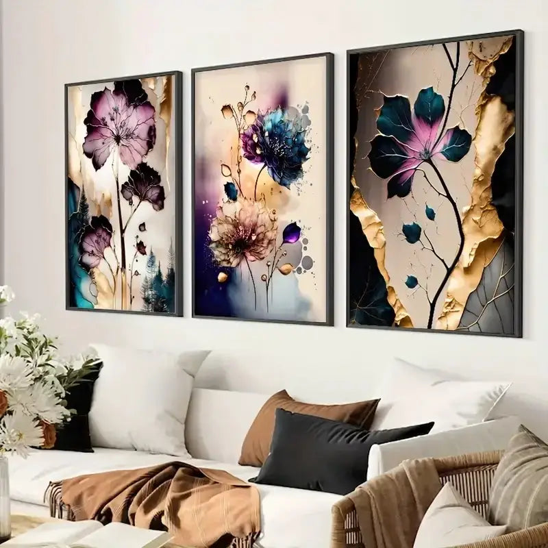 Three framed dreamy flowers canvas posters with vibrant purple blue and gold accents above a white sofa